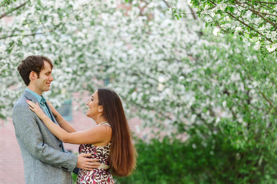 Springtime engagement portrait with blossoms in the background