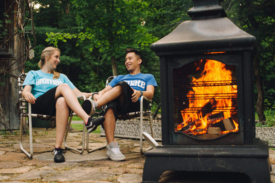 Backyard engagement shoot with fireplace and lawnchairs