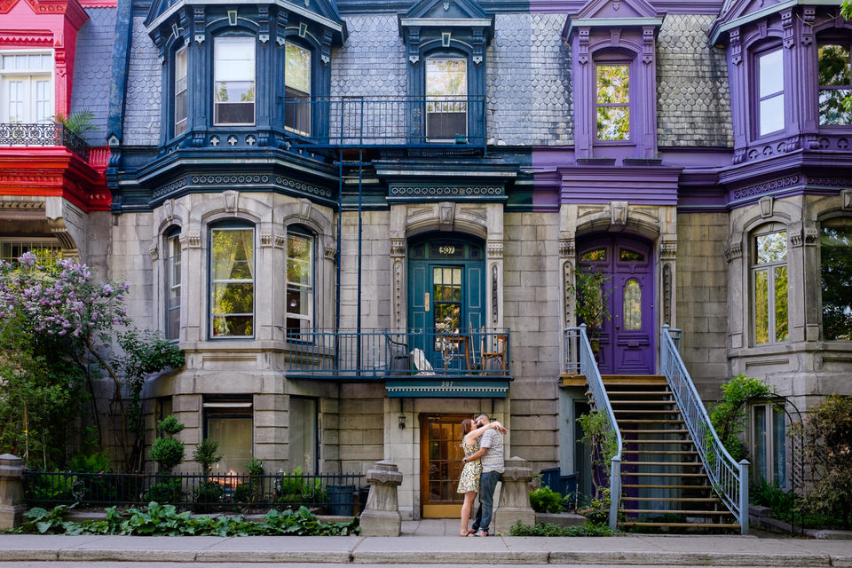 Engagement portrait in front of colourful painted houses in Plateau Mont-Royal neighbourhood