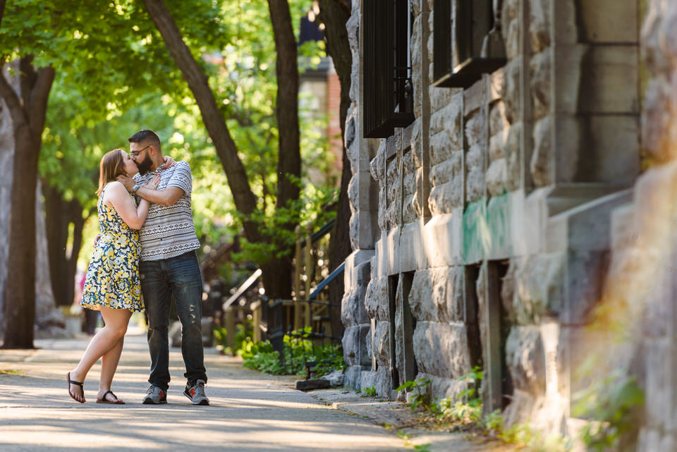 Couple kissing on the sidewalk in Montreal
