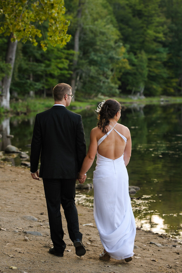 Wedding couple walking along the lake side