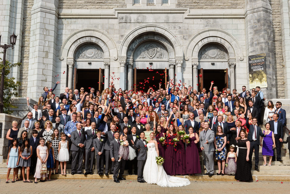 Big group photo with wedding guests on the steps of the Saint-Anges church in Lachine