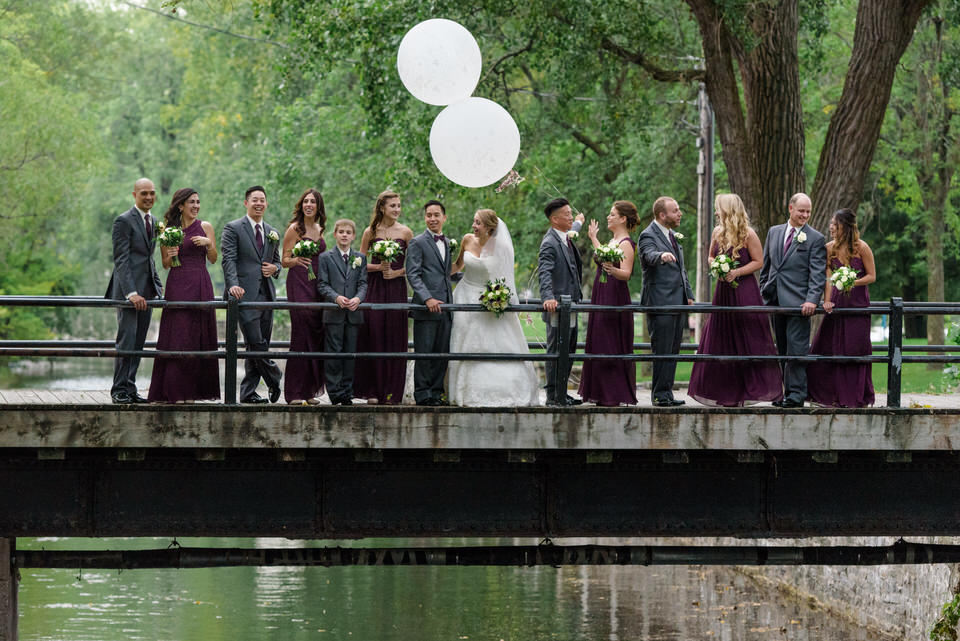 Wedding party with balloons on a bridge crossing the Lachine Canal