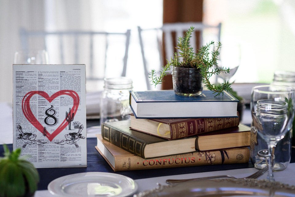 Cute nerdy wedding decorations featuring books and succulents