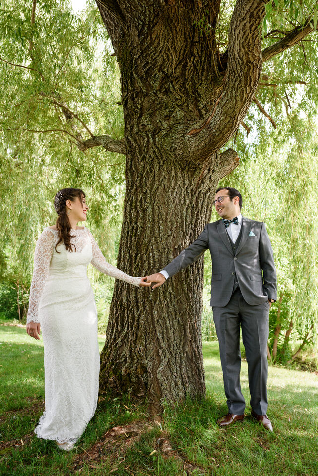 Wedding couple seeing each other for the first time under a willow tree
