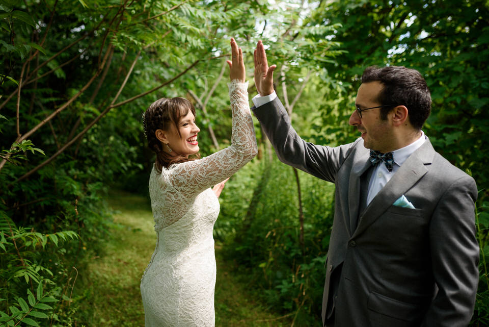 Wedding couple high fiving each other