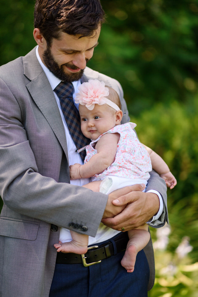 Man holding baby flower girl