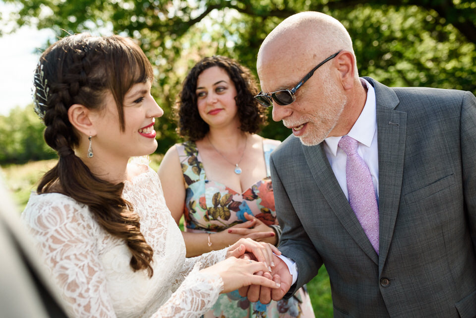 Bride's father admiring her wedding ring