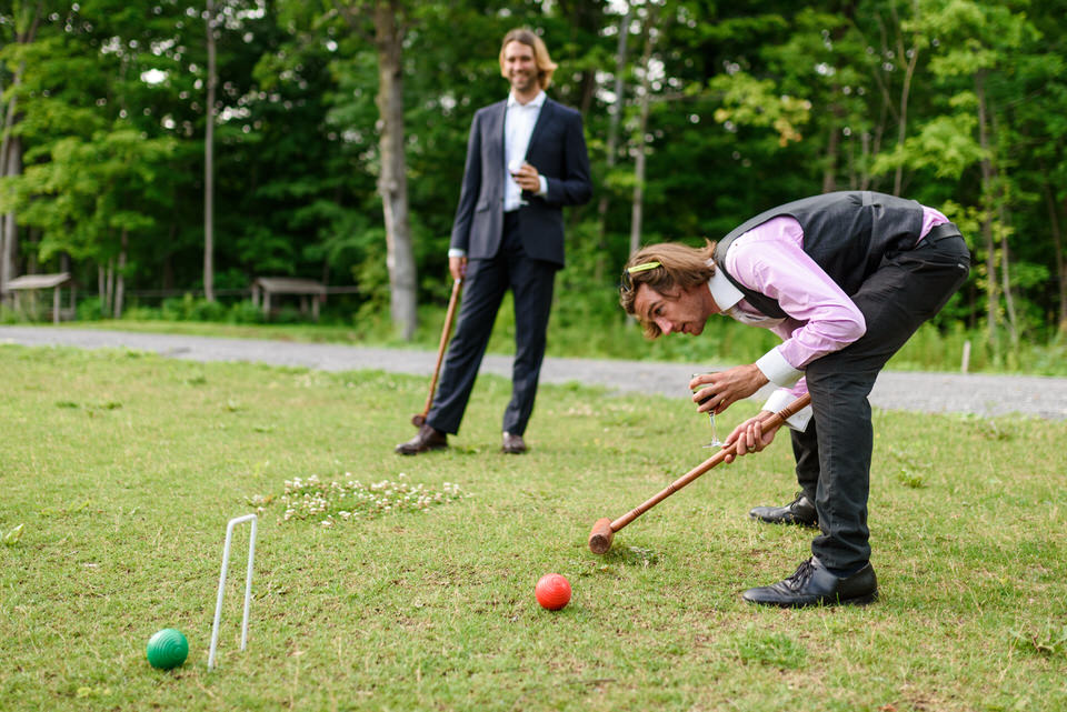 Two wedding guests playing croquet