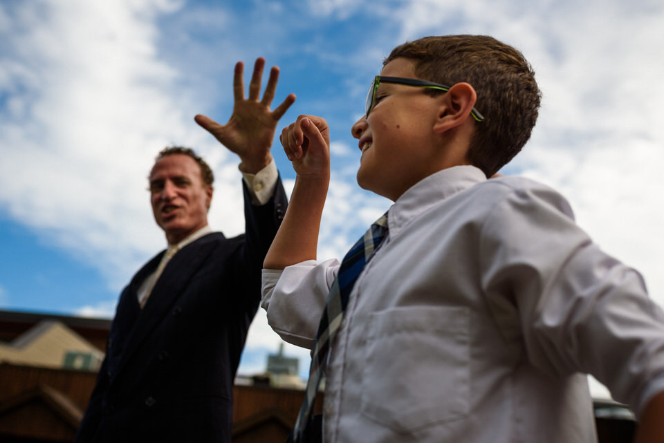 Man giving high five to kid at wedding