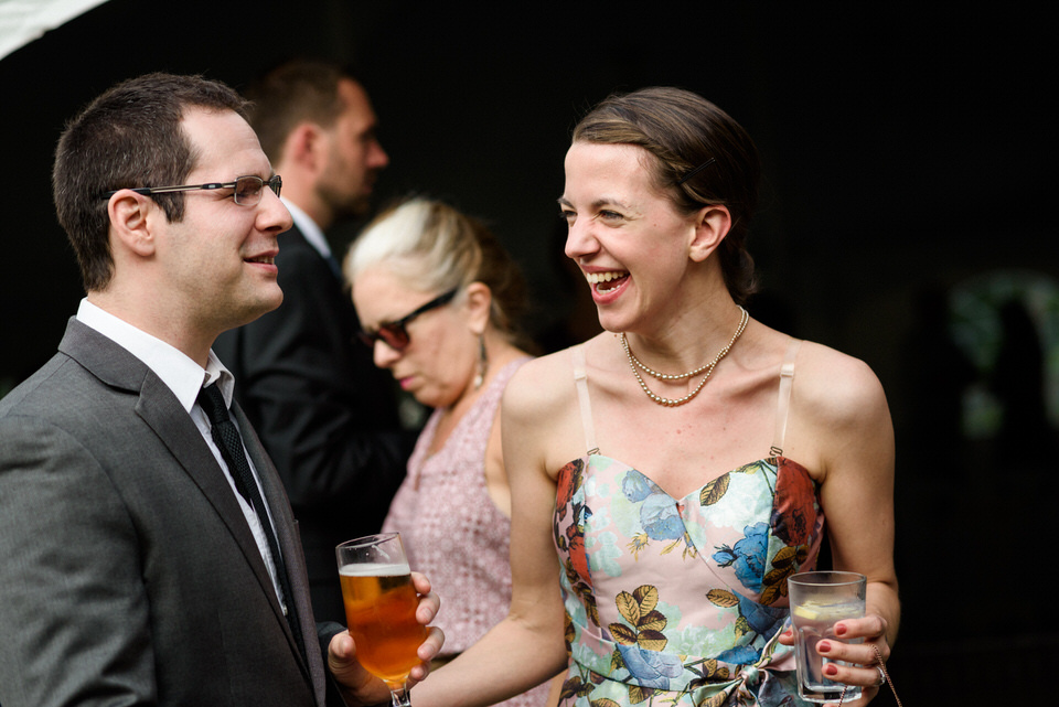Guests laughing together during cocktail hour