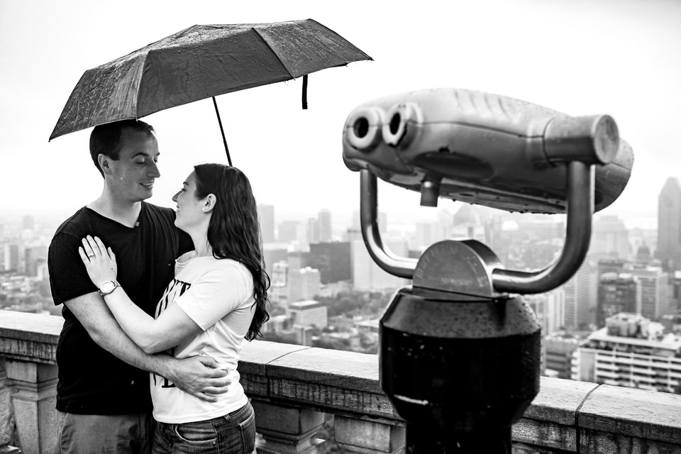 Just engaged couple in the rain under an umbrella