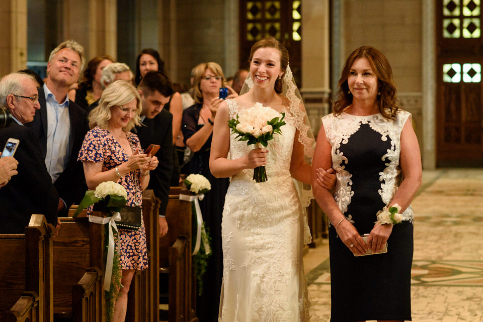 Bride and her mom walking up to front of church