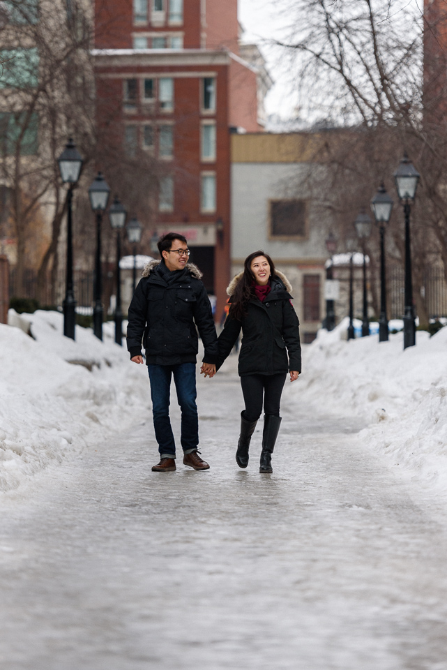 Winter engagement photo of couple walking hand in hand