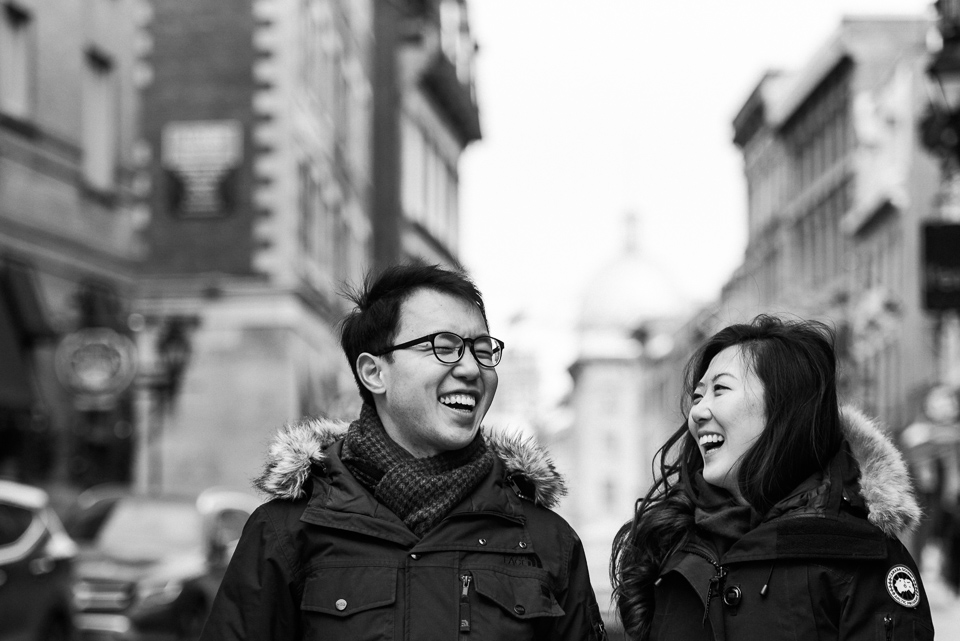 Laughing couple in winter surprise proposal photoshoot