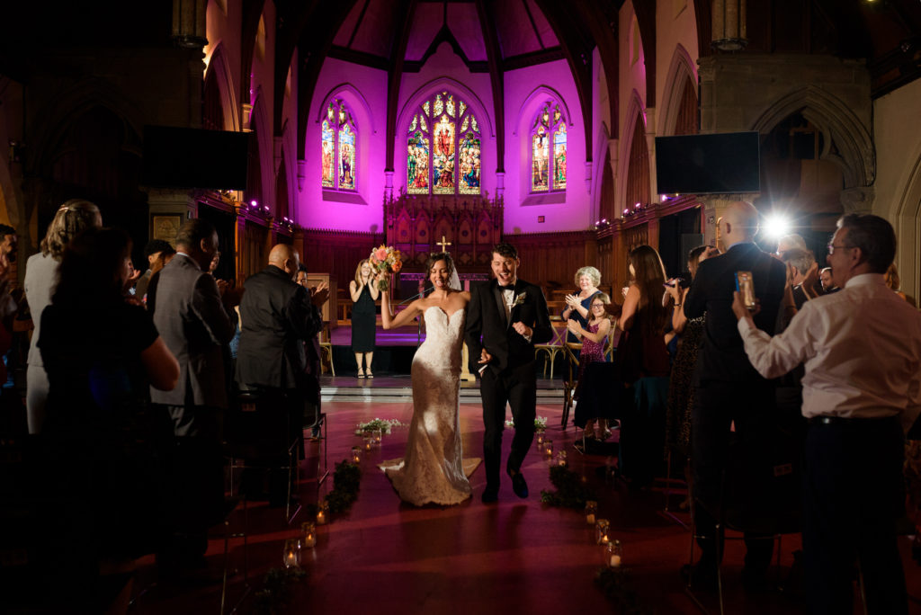 Newlyweds walk down the aisle after getting married at St Jax Montreal